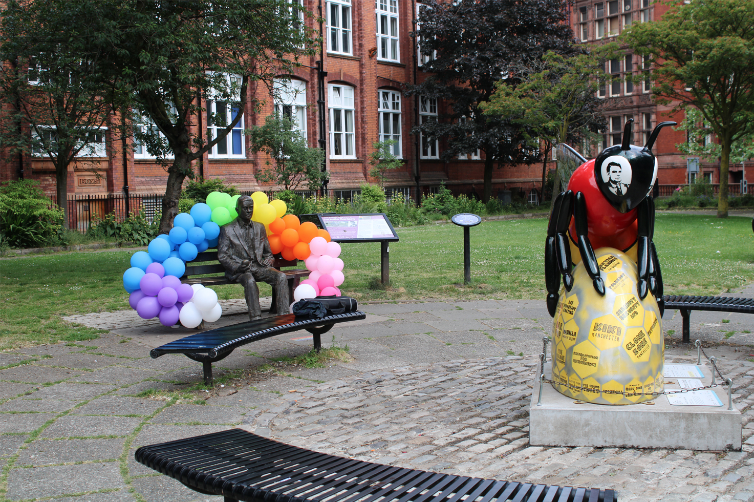The decorated memorial in Sackville Gardens, photographed besides the LGBTQ+ community bee.
