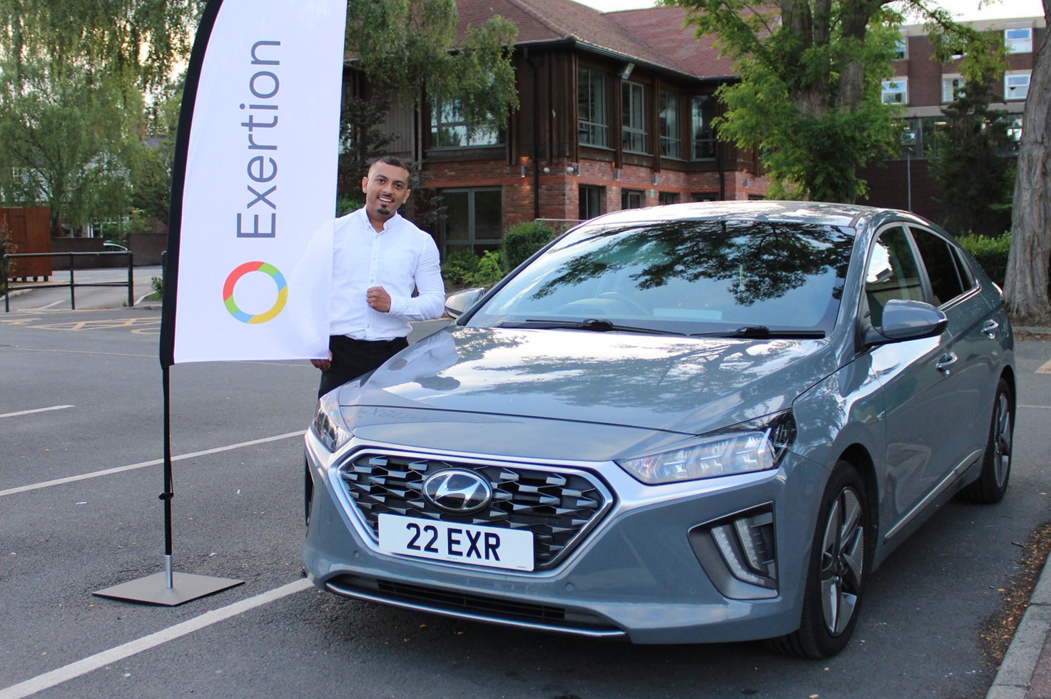 Our primary vehicle sporting the dateless "22 EXR" number plate, besides our company founder, Arif, holding an Exertion branded feather flag.